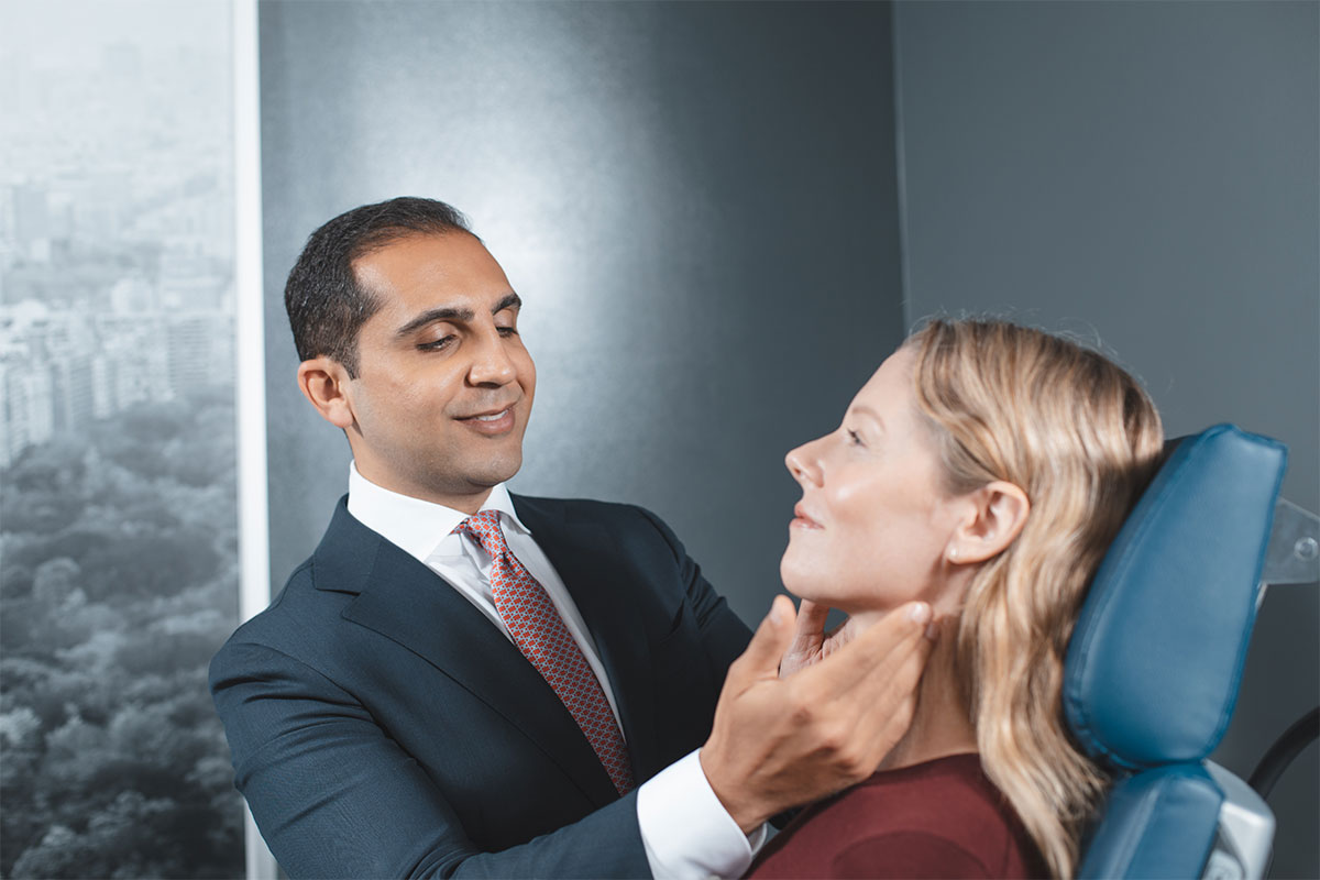 woman during exam for neck liposuction in NYC